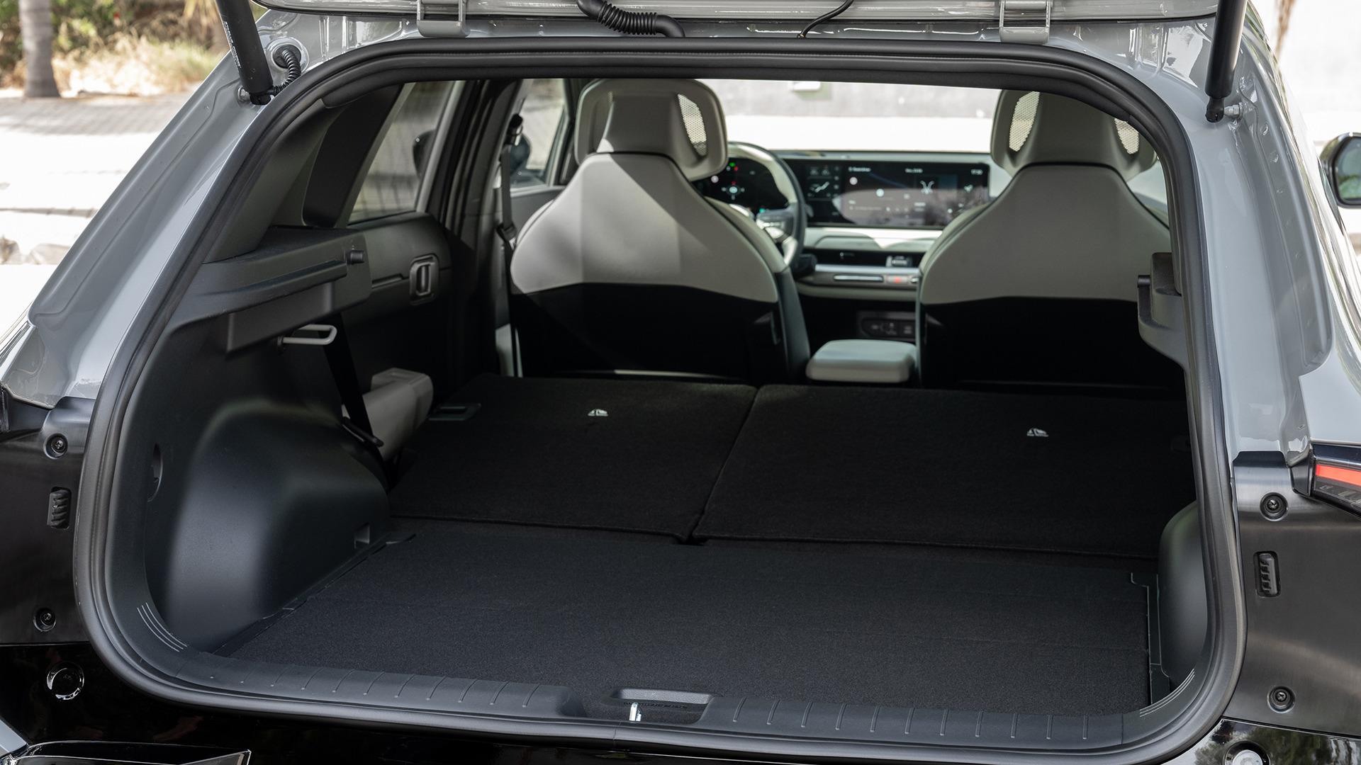 Kia EV4 hatchback cabin, showing the centre display and dark upholstery. Photo: Kia Europe