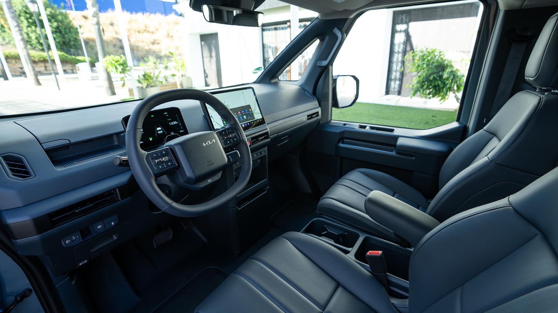 Kia PV5 Passenger cabin, showing the centre display and dark upholstery. Photo: Kia Europe
