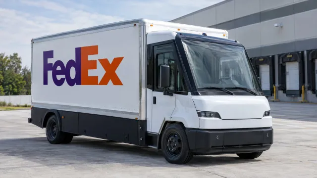 A FedEx-branded electric medium-duty box truck from Harbinger parked outdoors beside a FedEx logistics facility. AI-generated illustration.