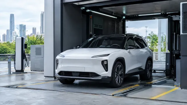 A white Nio ES6 parked inside a Nio battery swap station in Shenzhen, China, with the station's swap bay and charging equipment visible around the car. AI-generated illustration.