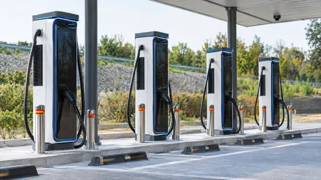 Two 400 kW and two 200 kW charging posts in a row at the Water fast-charging station at Cheongju Rest Area on the Gyeongbu Expressway in South Korea. AI-generated illustration.