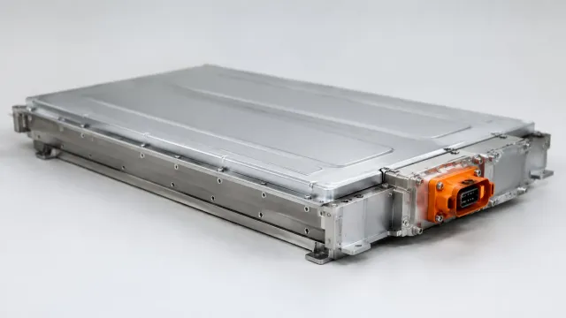 A flat silver Svolt semi-solid battery pack with an orange electrical connector, photographed against a plain background. AI-generated illustration.