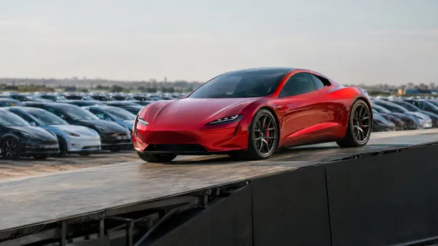 The second-generation Tesla Roadster on a large ramp during Tesla's reveal event in McGregor, Texas, with rows of parked Tesla vehicles behind it. AI-generated illustration.